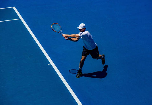 Tennis player lunging sideways for a ball