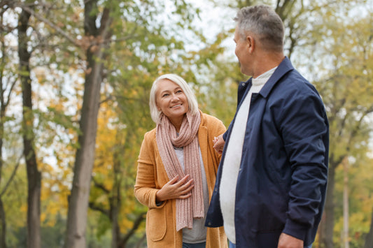 Older couple talking on an autumn walk in the park