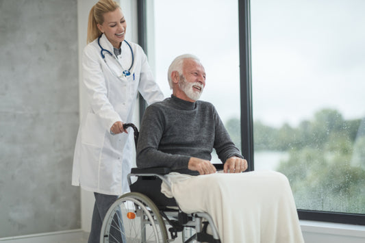 Doctor talking with a smiling older patient in a wheelchair