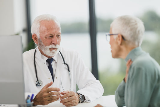 Doctor listening to an older patient during a consultation