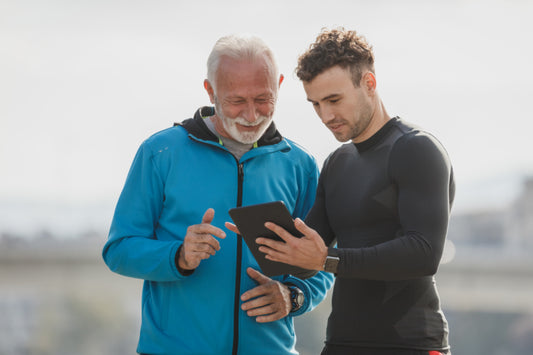 Older man talking with a trainer outdoors