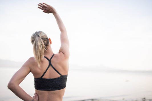 Woman stretching her arm and side outdoors