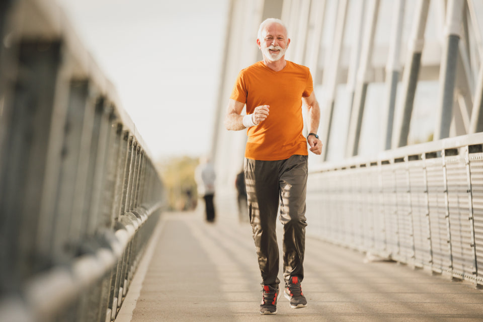 Older man running across a bridge