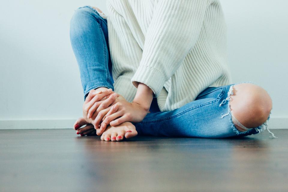 Woman sitting on the floor with her knees bent